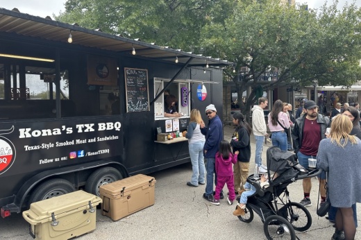 People stand in line in front of Kona's TX BBQ food truck.