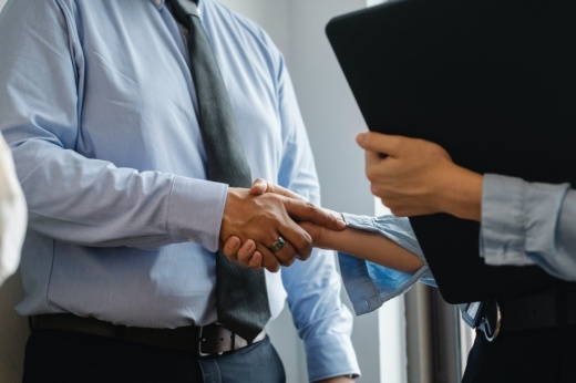 Two business people shaking hands.