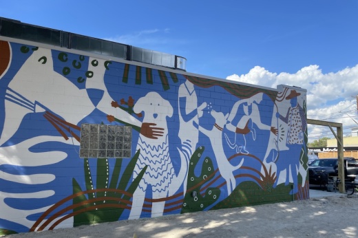 A look at the blue exterior of the building painted with white dog silhouettes.