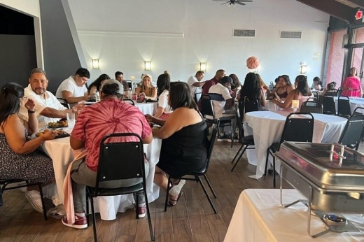 The dining room is filled with people eating.