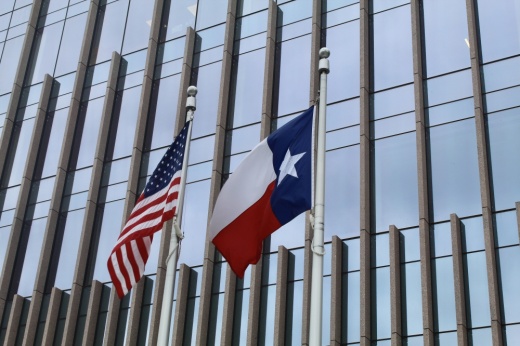 The United States and Texas flags at the Texas Capitol Complex.