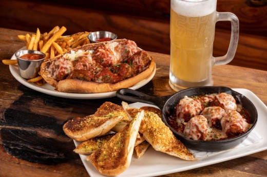 Meatball sandwich with fries and beer