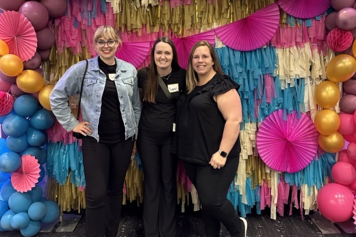 women standing in front of colorful backdrop