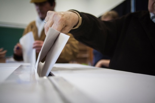 A person casts her ballot at a polling station