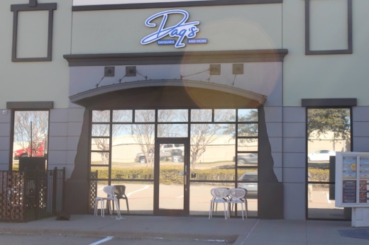 Front of a building with Daq's logo over the doors.