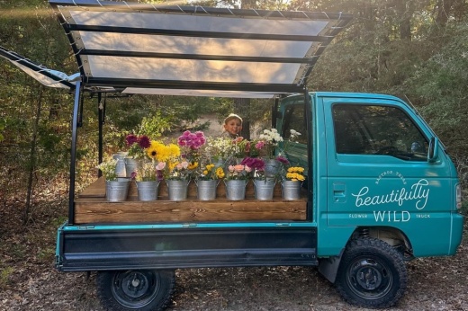 Amanda Gruetzner's son, Mason, poses near the turquoise truck.