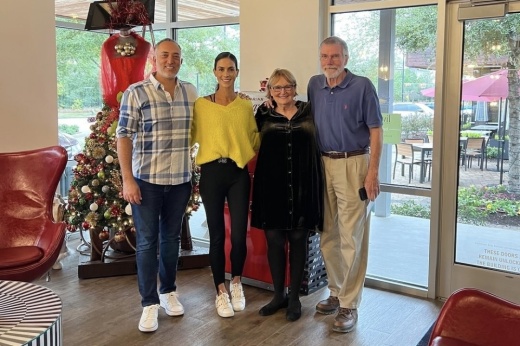 four people smiling and posing for a picture