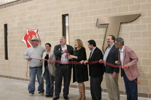 The image shows Tomball ISD's board of trustees and superintendent cutting a ribbon.