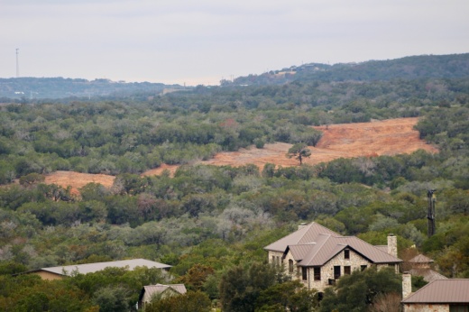 Construction on the Travis Club development can be seen from the Angel Bay neighborhood in Spicewood. (Kameryn Griesser/Community Impact)