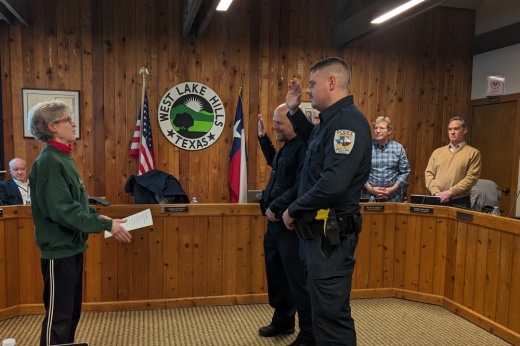 West Lake Hills police officers Ethan Atencio and Joseph Stephens take the ceremonial oath of office at a Jan. 24 meeting. (April Kelley/Community Impact)