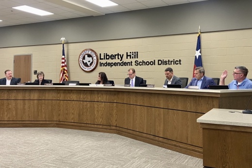 The Liberty Hill ISD board of trustees take a vote