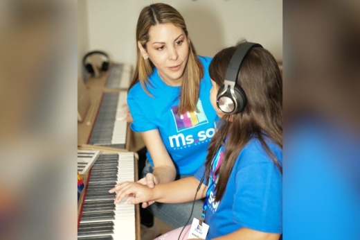 piano instructor guides student
