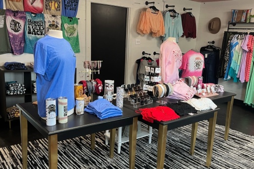 Two tables with clothing and cups on them