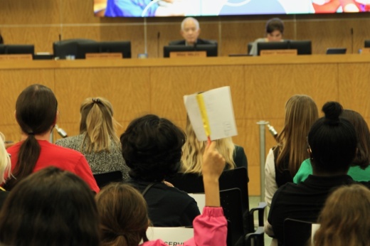 A shot of parents and community members listening to Houston ISD Superintendent Mike Miles during a board meeting.