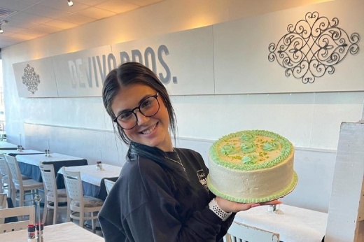 Devivo Bros. staff member with cake