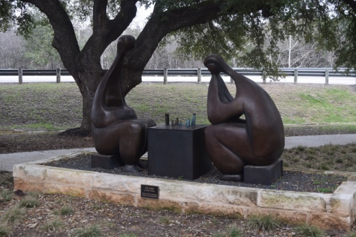 Sculpture of abstract people playing chess at Hurst Creek Sculpture Garden in Lakeway