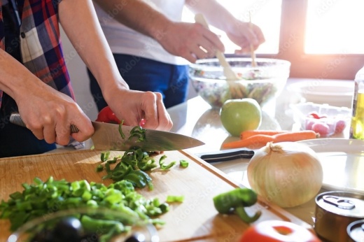 Two people cooking dinner together