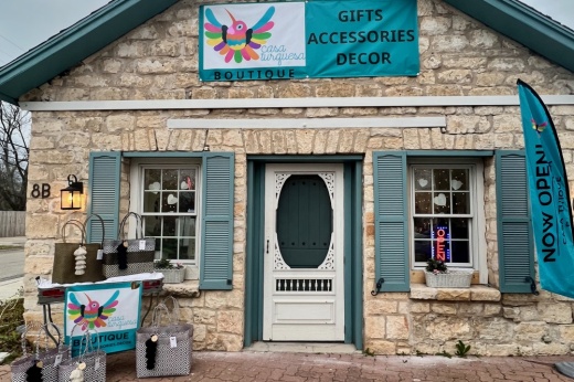 The exterior of a stone house with turquoise shutters