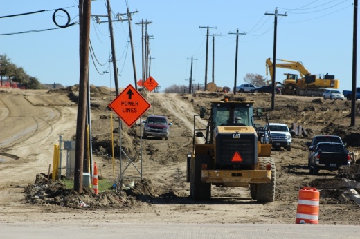 construciton work tears up a dirt road to extend Ownsby parkway