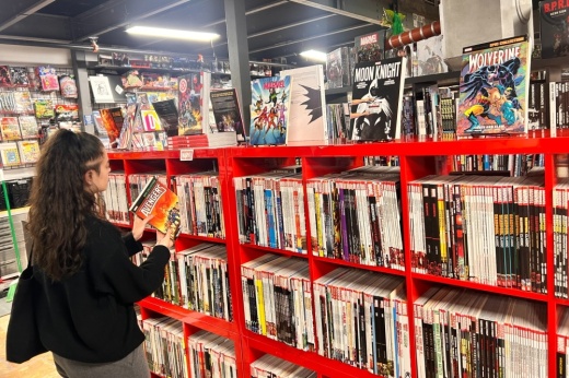 A patron of Space Cadets Collection Collection viewing a comic book.  (Shaheryar Khan/Community Impact)