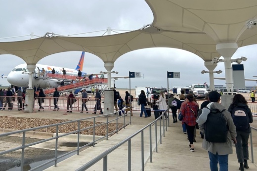 Passengers line up to board flight