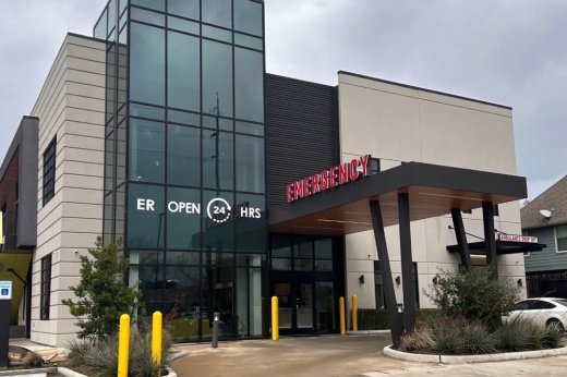 the front facade of an emergency room building with a drive-up area for ambulances
