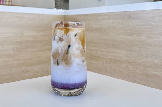 a blueberry iced latte in a glass cup from coffee u in frisco