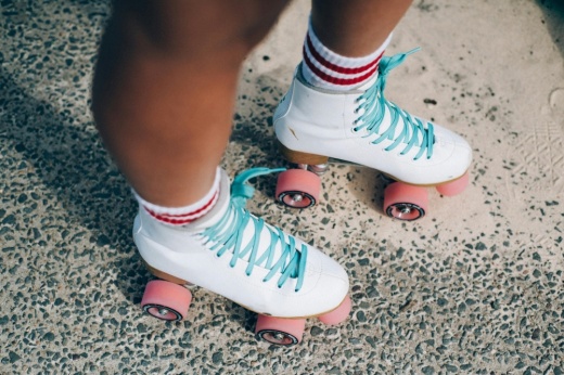 A person's feet is depicted wearing roller skates for the free Hutto event in Fritz Park.