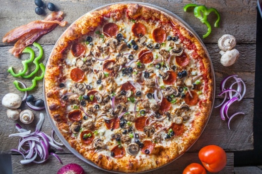 A pizza served at Parry's Pizzeria & Taphouse with ingredients surrounding the pizza. (Courtesy Parry's Pizzeria & Taphouse)