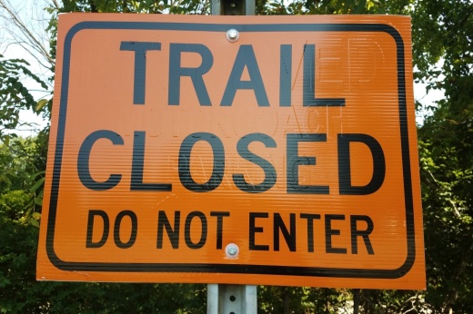 an orange trail closed do not enter sign