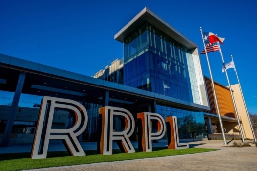 Large sign outside of library, indicating the initials for the Round Rock Public Library.