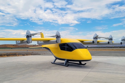a yellow aircraft sits on a runway