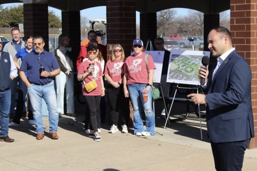 Picture of a man talking to a crowd.