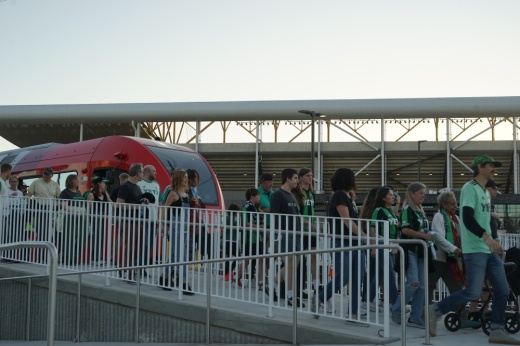 People exiting the train to the Q2 Stadium