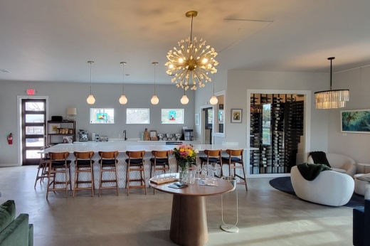 The image shows a newly renovated mid-century modern wine tasting room
