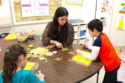 Britney Ramos, a teacher at Northside ISD’s Locke Hill Elementary School, works through a math lesson with a pair of third graders.
