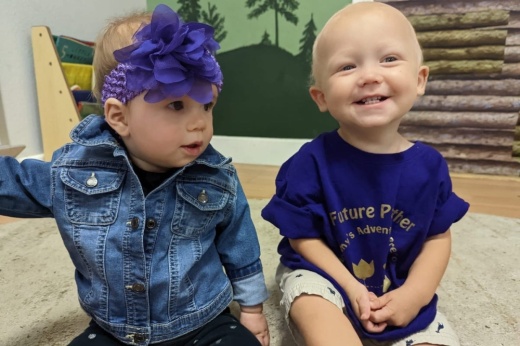 Two babies posing for photo