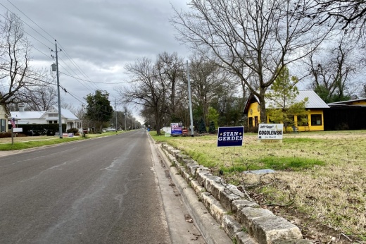 Election sign by a road.