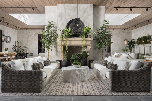 a nicely designed living room space with white couches and greenery