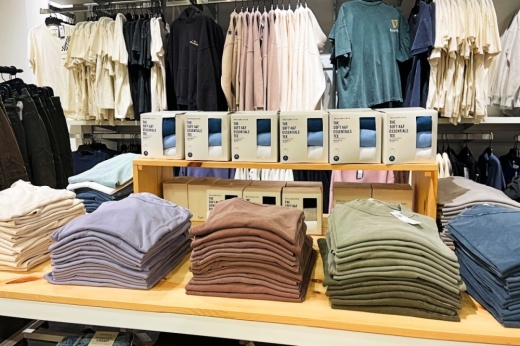 shirts on a shelf and hanging up inside Abercrombie and Fitch