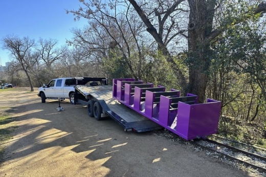 A new train car is dropped off at the train tracks at Zilker Park.