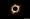 A zoomed in, high resolution photo of a total eclipse. The sun's rays are peering out in spikes from around the moon. you can see the entire moon's black shadow over the sun.