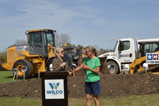 Valerie Covey holds Susan Blackledge's hand as she thanks her during a ground breaking event in Berry Springs Preserve.