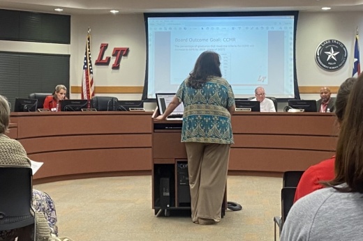 A woman presents to the board of trustees