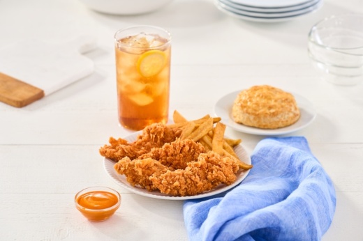 Plate of fried chicken, iced tea, biscuit