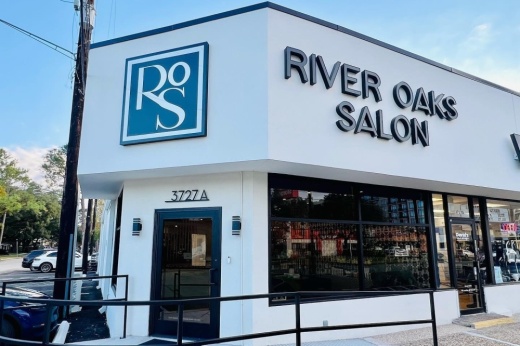 An exterior of a building with a sign for river oaks salon