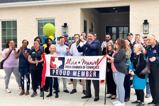 Balcara officials and community members cut the ribbon to commemorate the opening of the community. (Shaheryar Khan/Community Impact)