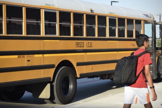 a student walks past a school bus