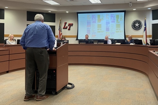 A man presents to the board of trustees