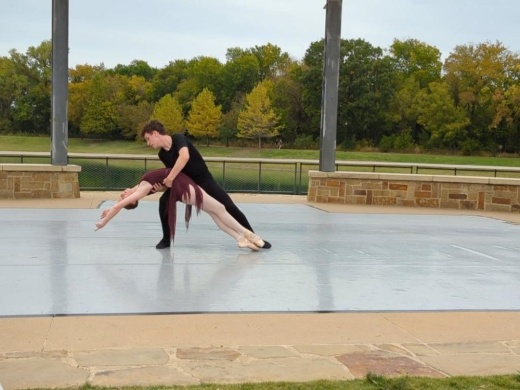 People performing ballet in the park.